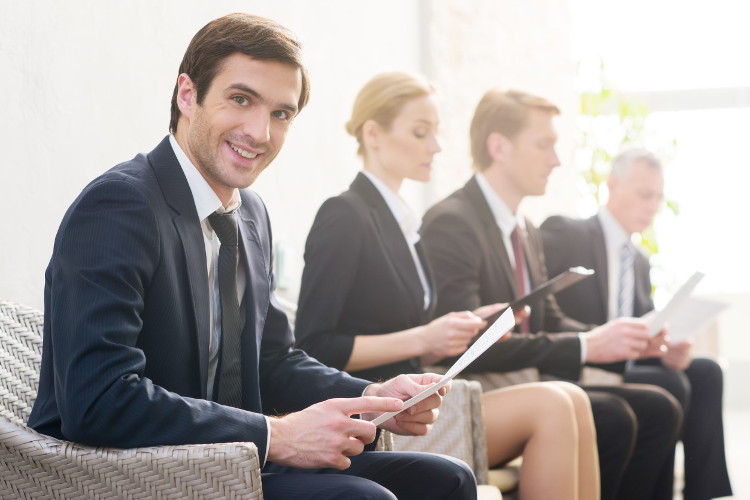 Confident candidate smiles while waiting for job interview